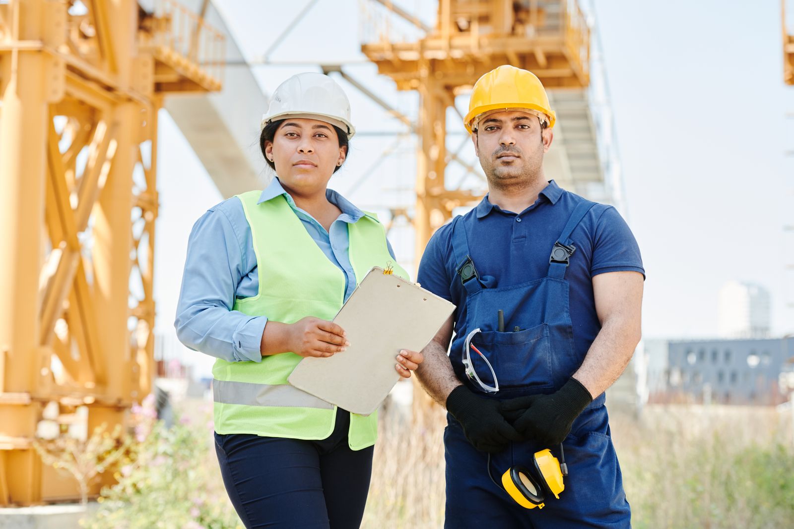 Two engineers wearing hard hats on a construction site