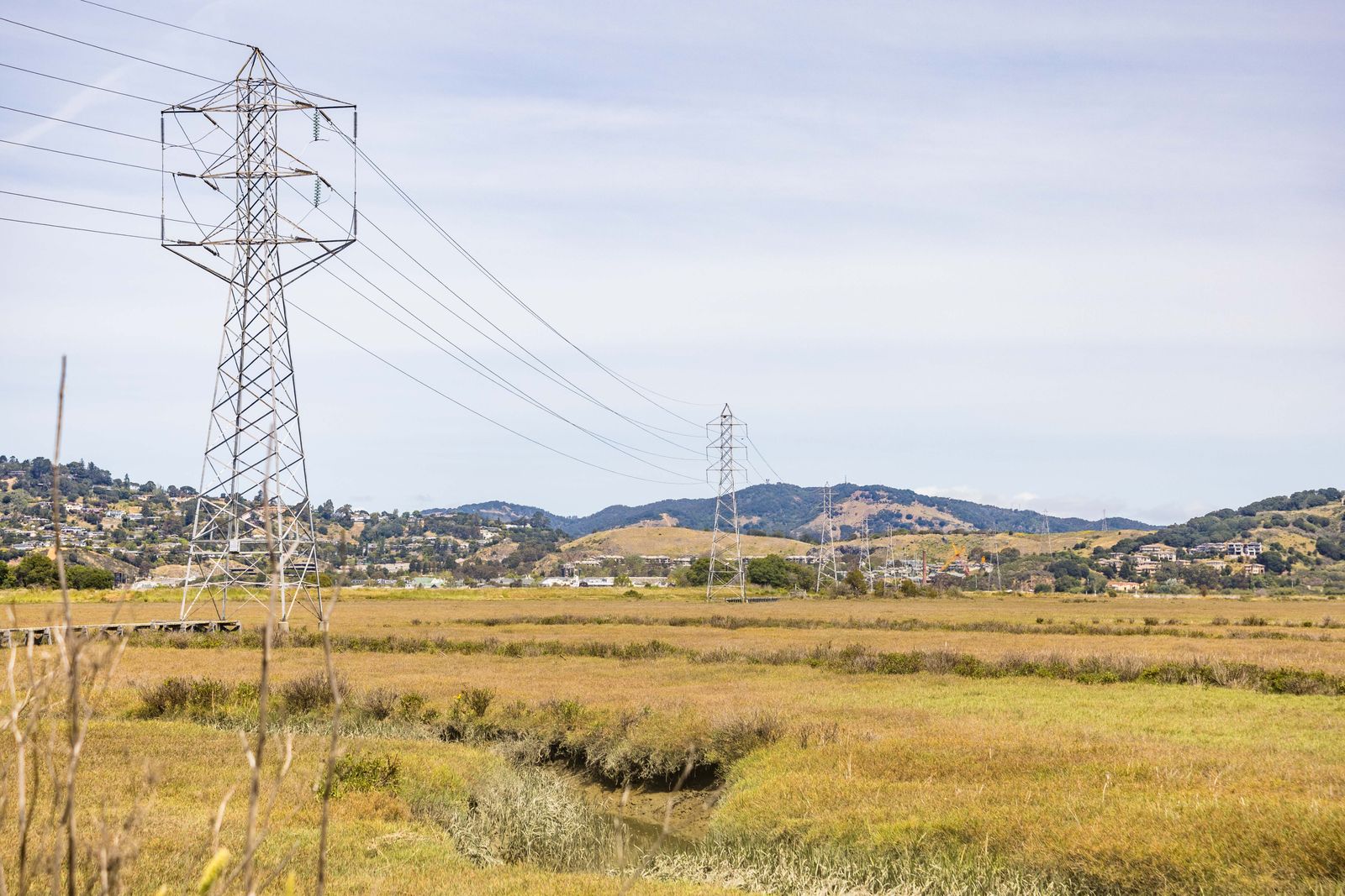 High-voltage power lines in an open landscape